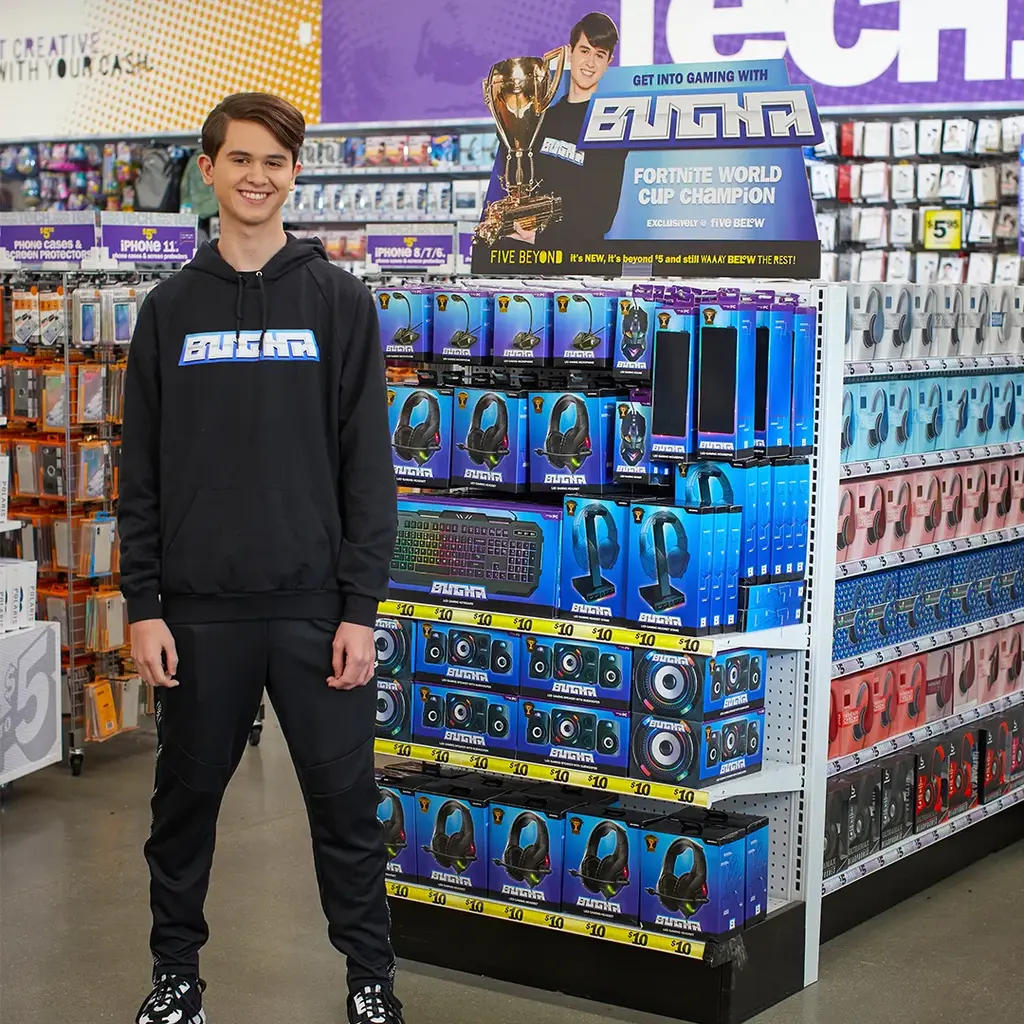 Bugha standing in front of the in-store gaming display at Five Below